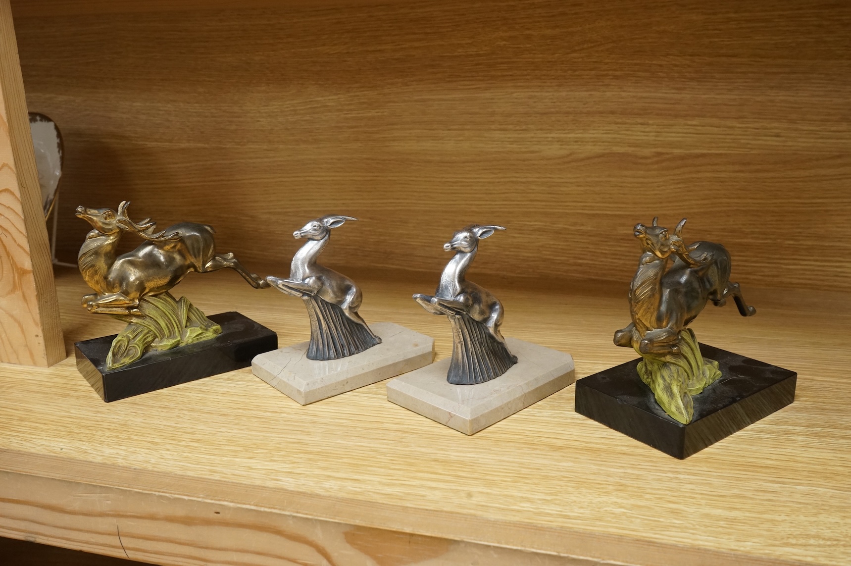Two pairs of Art Deco bookends in the form of leaping animals, largest 14cm wide